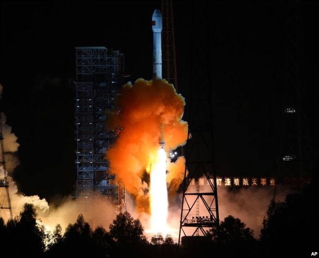 In this photo released by China's Xinhua News Agency, the the unmanned Chang’e 5-T1 spacecraft is launched atop an advanced Long March 3C rocket from the Xichang Satellite Launch Center in southwest China's Sichuan Province, Friday, Oct. 24, 2014. (AP Pho