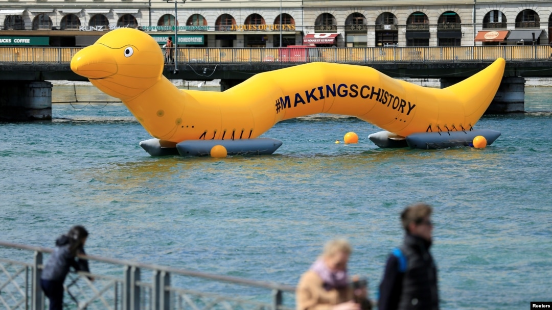 FILE - A giant 25m worm representing the parasitic worm of schistosomiasis, that causes significant suffering and death to thousands of people around the world, is pictured on the Lake Leman on the occasion of the Neglected Tropical Diseases Summit, in Geneva, Switzerland, April 18, 2017.