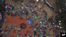 Central American migrants gather in an area designated for them to set up their tents in Tijuana, Mexico, Nov. 21, 2018.