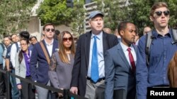 FILE - Job seekers line up at TechFair in Los Angeles, California, March 8, 2018.
