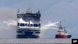 FILE - Smoke rises from the Italian-flagged Euroferry Olympia, in the Ionian Sea near the Greek island of Corfu, on Feb. 20, 2022.