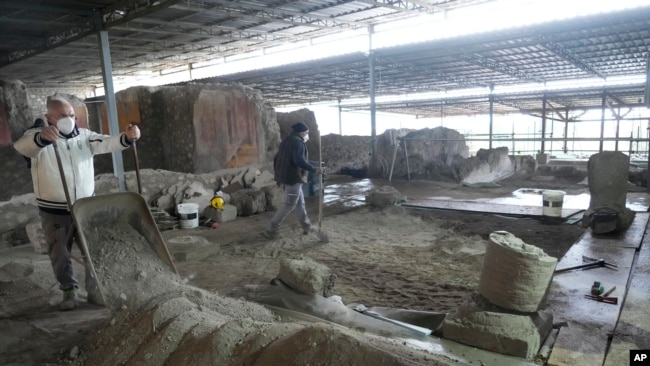 Excavations are carried out inside the 'House of the library' at the Pompeii archaeological site, Feb. 15, 2022. (AP Photo/Gregorio Borgia)