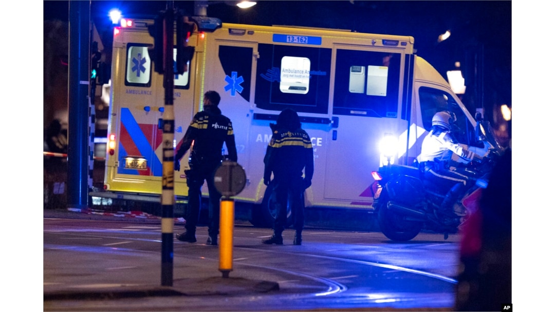 An ambulance transporting the injured hostage taker leaves the scene in Amsterdam, Netherlands, Feb. 22, 2022.