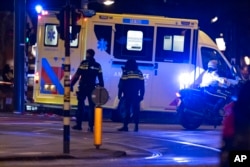 An ambulance transporting the injured hostage taker leaves the scene in Amsterdam, Netherlands, Feb. 22, 2022.