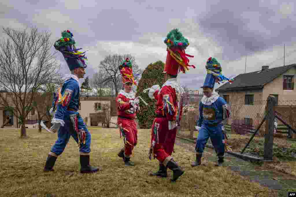 People dressed in traditional Czech folklore costumes dance as they parade through the village of Blatno, part of the Hlinsko town near the east Bohemian city of Pardubice, Czech Republic, during the traditional Masopust carnival celebration.
