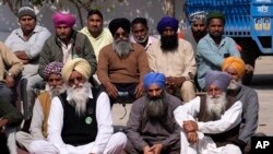 A group of village elders listen to the speech of one of the candidate contesting for the state assembly elections in village Derra Bassi, in Indian state of Punjab, Monday, Feb. 14, 2022.