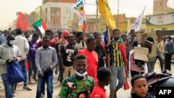 Demonstrators march during ongoing protests calling for civilian rule and denouncing the military administration, in the Sahafa neighborhood in the south of Sudan's capital Khartoum, Feb. 20, 2022. 