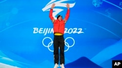 Gold medalist Bart Swings of Belgium celebrates during a medal ceremony for the men's speed skating mass start finals at the 2022 Winter Olympics, in Beijing, China, Feb. 19, 2022. 