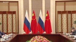 Illustration of the Russian Flag (left and third from left) and the flag of the People's Republic of China (second from left and far right). Uploaded February 23, 2022. 