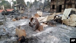 FILE - Charred homes sit in piles of ash in Mwe Tone village of Pale township in the Sagaing region, Myanmar, Feb. 1, 2022. 