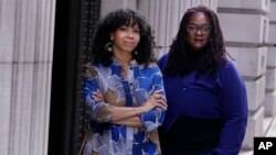 Amber Payne, left, and Deborah Douglas co-editors-in-chief of the new online publication of "The Emancipator" pose together, Feb. 2, 2022, in Boston.