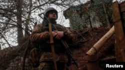 A Ukrainian service member stands on the front line near the city of Novoluhanske in the Donetsk region, Feb. 22, 2022. 