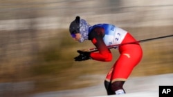 Dinigeer Yilamujiang of China competes during the women's sprint free cross-country skiing competition at the 2022 Winter Olympics, Feb. 8, 2022, in Zhangjiakou, China.