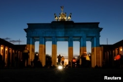 The Brandenburg Gate is illuminated in Ukrainian national colors, in Berlin, Germany, Feb. 23, 2022.