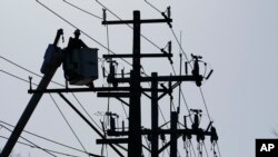 FILE - A worker works on the power lines in Annapolis, Maryland., on Dec. 15, 2021. 