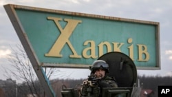 2022年2月17日，在乌克兰哈尔科夫的一次联合行动中，一名乌克兰国民警卫队士兵与乌克兰安全局特工和警察一起守卫移动检查站。