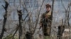 (FILE) A North Korean prison policewoman stands guard behind fences at a jail on the banks of Yalu River near the Chongsong county of North Korea, opposite the Chinese border city of Dandong, May 8, 2011. Picture taken May 8, 2011.