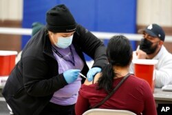 A Pfizer COVID-19 vaccine is administered at a recreation center in Wilmington, California, April 13, 2021.
