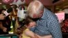 A man hugs his granddaughter Charlotte Roempke upon arriving at Sydney International Airport, Feb. 21, 2022, as Australia reopened its borders for fully vaccinated visa holders, tourists and business travelers. 