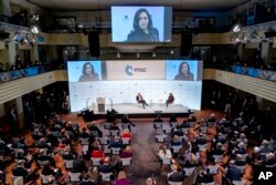 U.S. Vice President Kamala Harris, right on stage, speaks during the Munich Security Conference, as conference chairman Wolfgang Ischinger, left on stage, looks on, in Munich, Germany, Feb. 19, 2022.