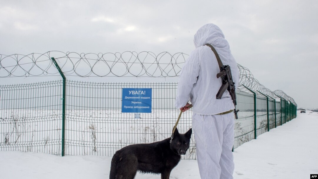 A Ukrainian frontier guard patrols along the border with Russia, some 40 kilometers from the Ukrainian city of Kharkiv, on Feb. 16, 2022. 