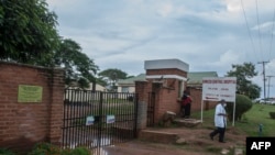 Un médecin passe devant l'entrée principale du principal centre de traitement COVID-19 de l'hôpital central de Kamuzu à Lilongwe, au Malawi, le 18 janvier 2021.