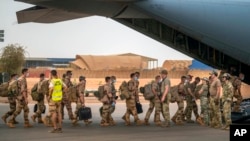 FILE - French Barkhane force soldiers leave their base on a transport plane in Gao, Mali, June 9, 2021, having completed a tour of duty. French President Emmanuel Macron announced at a press conference Feb. 17, 2022, that he is withdrawing French forces from the country.