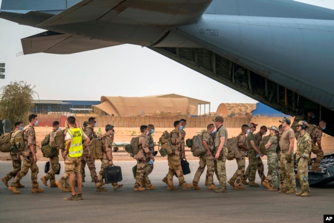 FILE - French Barkhane force soldiers who wrapped up a tour of duty in the Sahel leave their base on a transport plane in Gao, Mali, June 9, 2021. French President Emmanuel Macron announced Feb. 17, 2022, that he is withdrawing French troops from Mali.