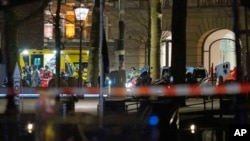 Police special intervention units and rescue workers are seen next to the Apple Store, two windows at right, in Amsterdam, Netherlands, Feb. 22, 2022.