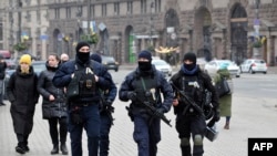 FILE - Ukrainian police officers patrol a street in central Kyiv on Feb. 16, 2022.