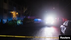 Police investigate the crime scene, where according to the Portland Police Bureau one person was shot dead and five others were wounded, at Normandale Park in Portland, Oregon, U.S., February 19, 2022.