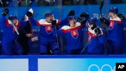 Slovakia bench celebrates a goal by teammate Juraj Slafkovsky during the men's bronze medal hockey game against Sweden at the 2022 Winter Olympics, Feb. 19, 2022, in Beijing.