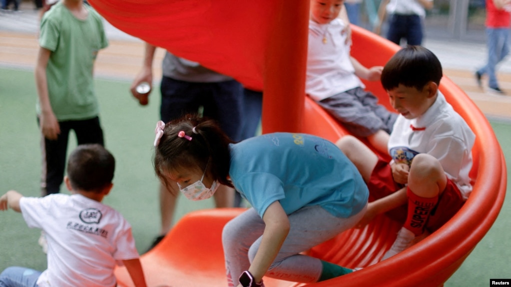 FILE - Children at a playground inside a shopping complex in Shanghai, China, June 1, 2021.