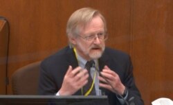 In this image from video, Dr. Martin Tobin testifies as Hennepin County Judge Peter Cahill presides before the court, April 15, 2021, in the trial of former Minneapolis police officer Derek Chauvin at the Hennepin County Courthouse in Minneapolis.