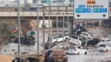 Damaged cars are seen along a road affected by torrential rains that caused flooding, on the outskirts of Valencia, Spain, October 31, 2024. (REUTERS/Eva Manez)