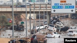 Damaged cars are seen along a road affected by torrential rains that caused flooding, on the outskirts of Valencia, Spain, October 31, 2024. (REUTERS/Eva Manez)