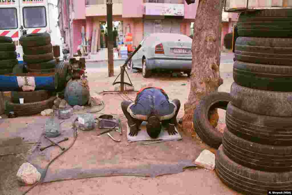 A man prays as the sun sets on a Ramadan evening and another day of fasting, May 23, 2018, in Dakar, Senegal. 