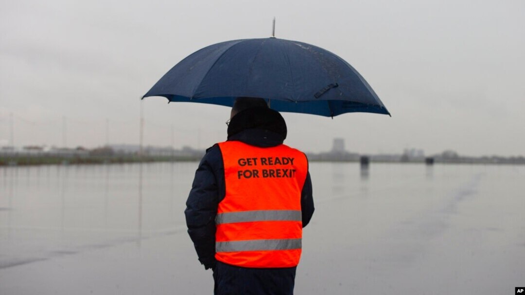 A spokesperson wears a safety vest during a press tour of an overflow parking lot for trucks after the Brexit transition period, in Hook of Holland, near Rotterdam, Netherlands, Dec. 21, 2020.