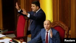 FILE - Ukrainian Parliament Speaker Andriy Parubiy (seated) and Ukrainian Prime Minister Volodymyr Groysman (L) are see during a parliament session in Kyiv, Ukraine, Dec. 20, 2016.