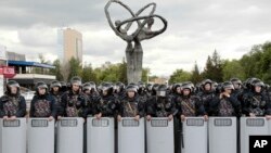 Kazakh police block an area to prevent protests against presidential elections in Nur-Sultan, the capital city of Kazakhstan, on Monday June 10, 2019.
