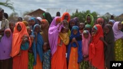 FILE - Refugees gather to watch the arrival of United Nations High Commissioner for Refugees Antonio Guterres at IFO-2 complex of the sprawling Dadaab refugee camp, May 8, 2015.