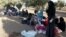 Newly-arrived Syrian refugee families rest after having crossed the border from Tal Shehab in Syria, through the Al Yarmouk River valley, to near Ramtha, Jordan, Sept. 15, 2012.