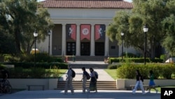 FILE - Students walk past the Thorne Hall at Occidental College campus in Los Angeles, July 27, 2023. 