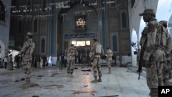 Pakistani para-military soldiers stand alert after a deadly suicide attack at the shrine of famous Sufi Lal Shahbaz Qalandar in Sehwan, Pakistan, Feb. 16, 2017.