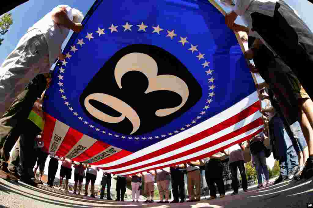 Visitors to the Flight 93 National Memorial in Shanksville, Pa., participate in a sunset memorial service, Sept. 10, 2019, as the nation prepares to mark the 18th anniversary of the 9/11 attacks.