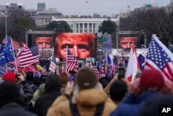 FILE - Trump supporters participate in a rally in Washington, Jan. 6, 2021, with some later storming the U.S. Capitol.