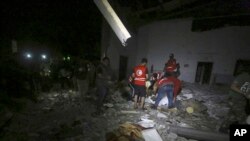 Libyan Red Crescent workers recover migrants bodies after an airstrike at a detention center in Tajoura, east of Tripoli, July 3, 2019. 