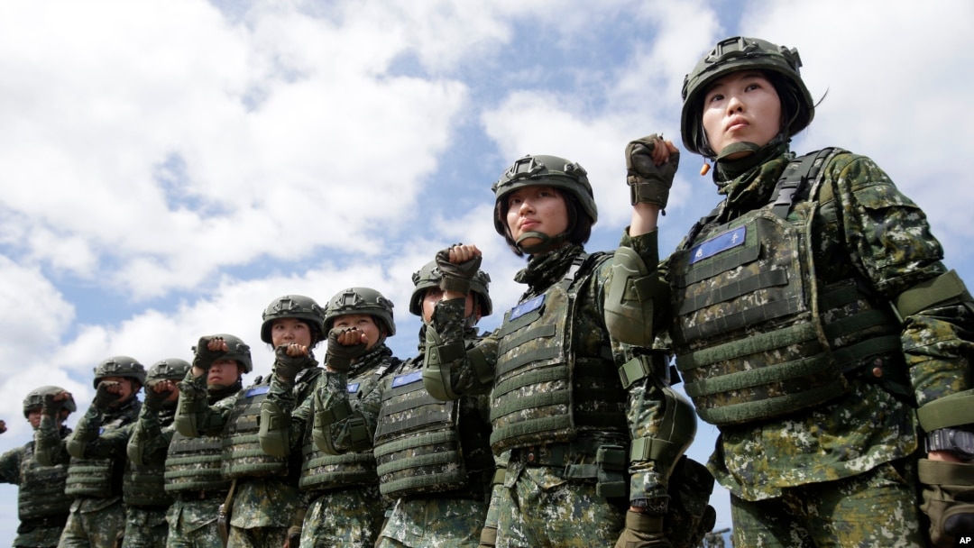 FILE - The first team of Taiwan artillerywomen poses for the press during the annual Han Kuang exercises in Pingtung County, Southern Taiwan, May 30, 2019. The U.S. approved the sale of $2.2 billion worth of military equipment to Taiwan, July 9, 2019.
