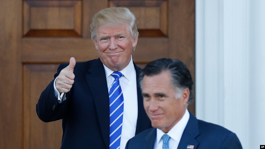 President-elect Donald Trump gives the thumbs-up as Mitt Romney leaves Trump National Golf Club Bedminster in Bedminster, N.J., Nov. 19, 2016. 