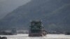 FILE - Chinese cargo ships sail on the Mekong River near the Golden Triangle at the border between Laos, Myanmar and Thailand March 1, 2016.